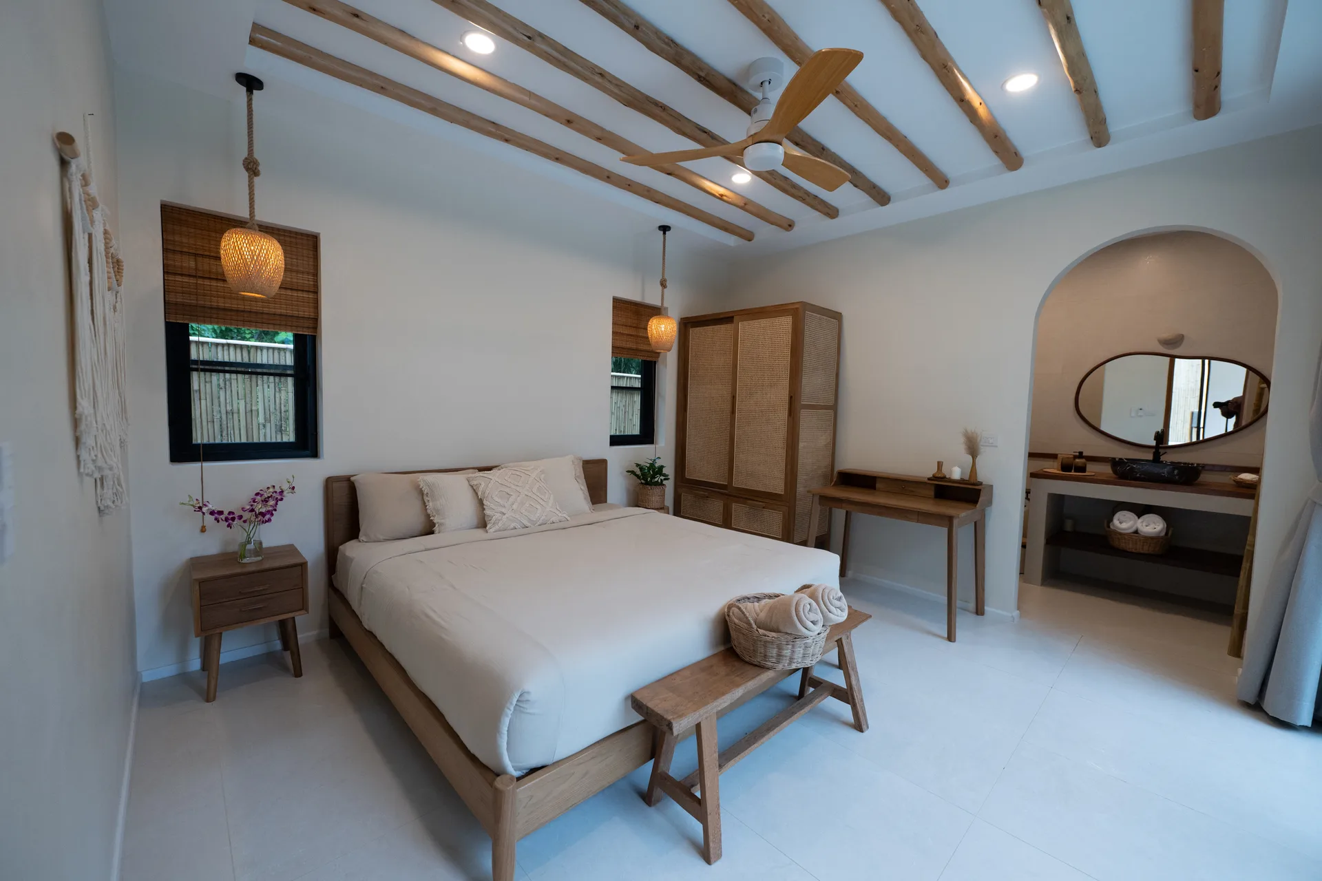 Central Villa king bedroom with natural wood and rattan furniture